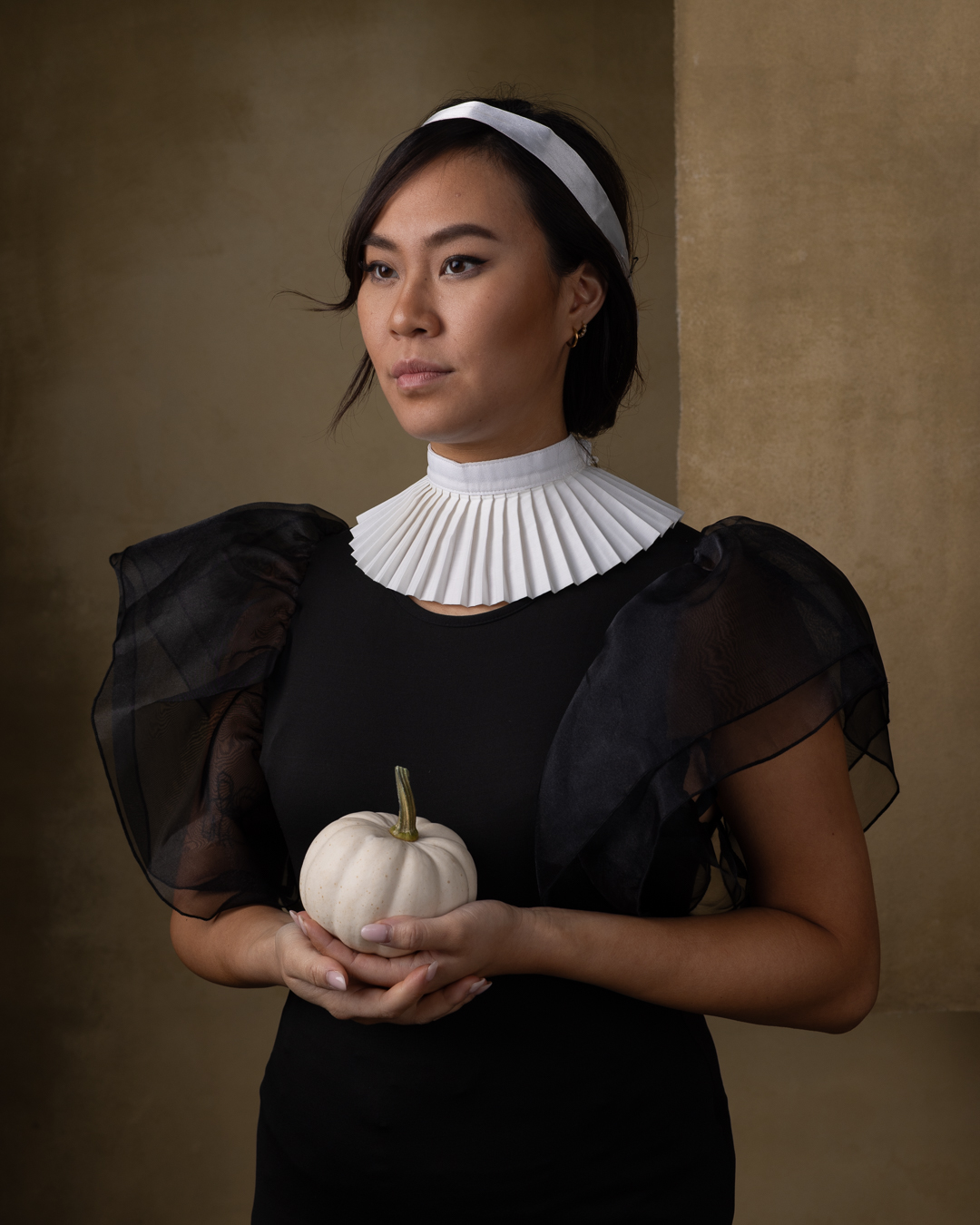 Original RAW portrait with a pleated collar before editing