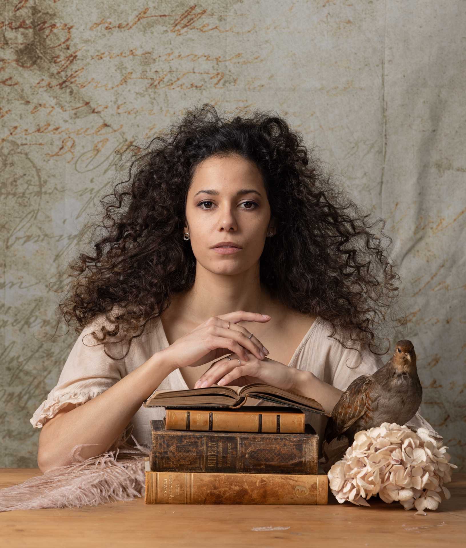 Original RAW portrait with books and a bird before editing